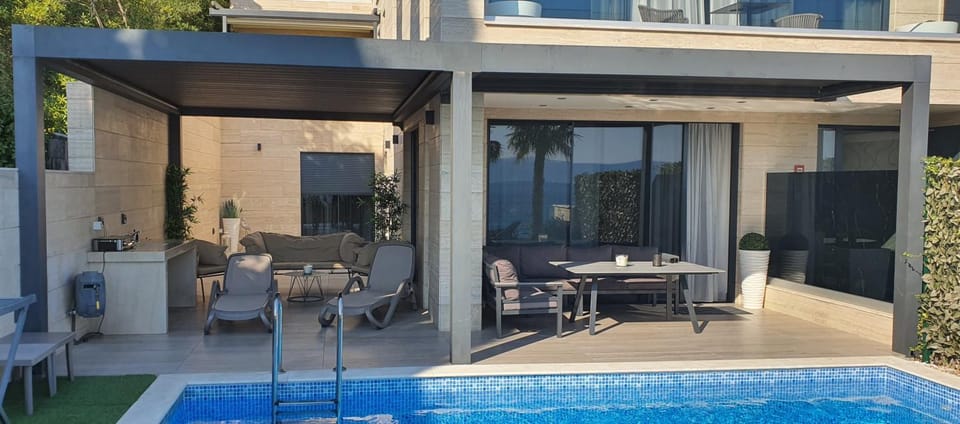 Property building, Patio, Day, Living room, Seating area, Dining area, Pool view, Swimming pool, sunbed