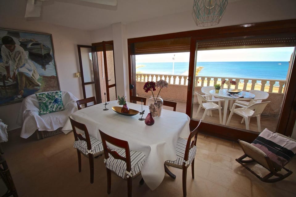 Natural landscape, View (from property/room), Balcony/Terrace, Living room, Seating area, Dining area, Beach, Sea view, fireplace