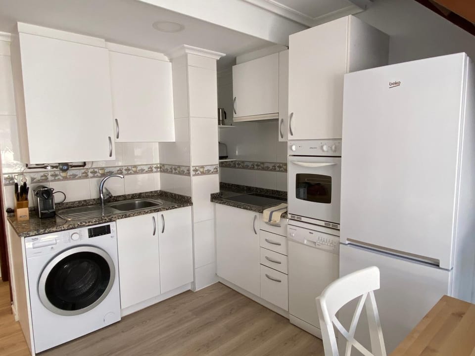 Kitchen or kitchenette, dishwasher, oven, stove, washing machine