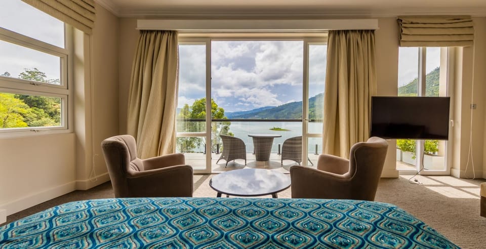 Bed, TV and multimedia, Seating area, Bedroom, Lake view