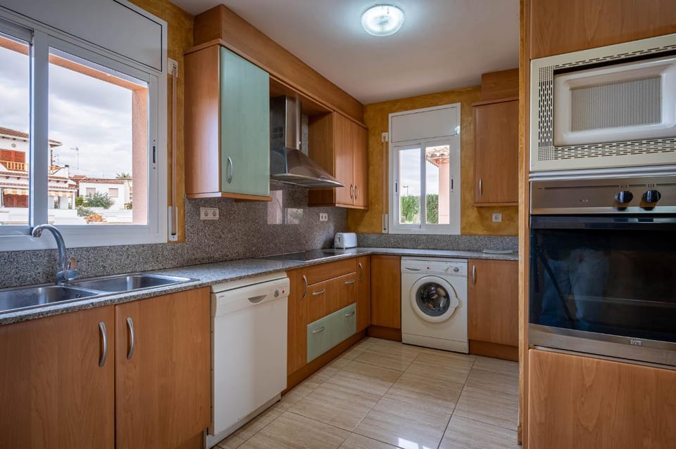 Kitchen or kitchenette, dishwasher, oven, stove, washing machine
