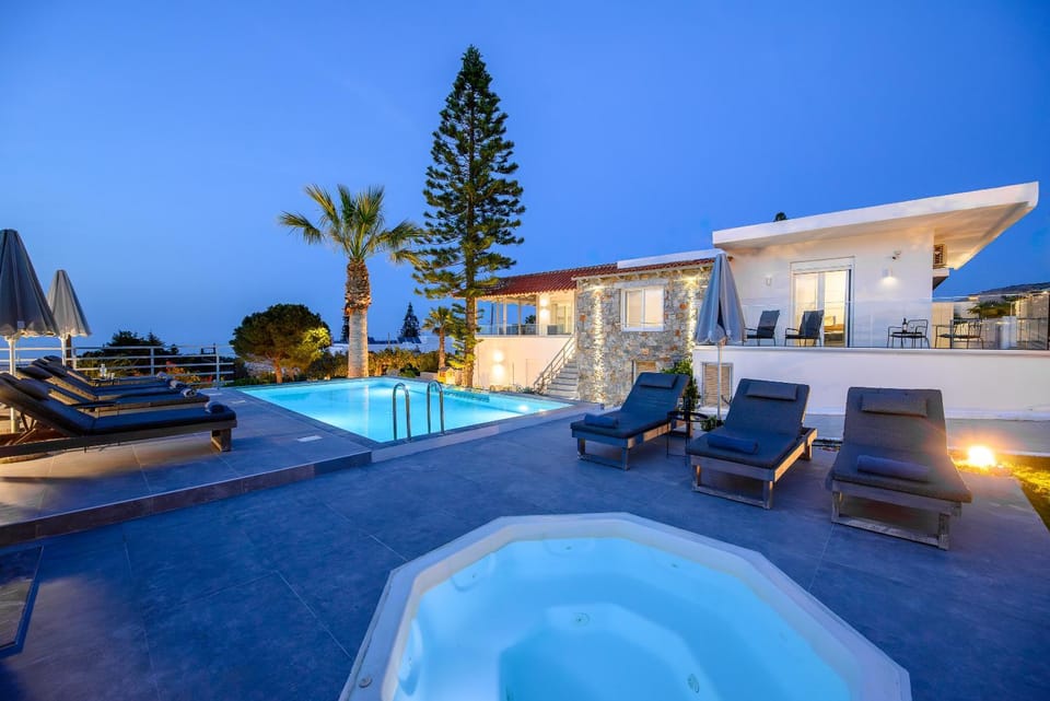 Property building, Patio, Night, Natural landscape, Living room, Seating area, Pool view, Swimming pool, sunbed