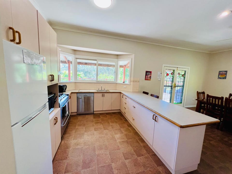 Kitchen or kitchenette, dishwasher, oven, stove