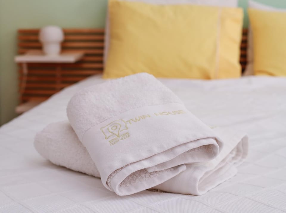 Bed, Property logo or sign, Bedroom, towels