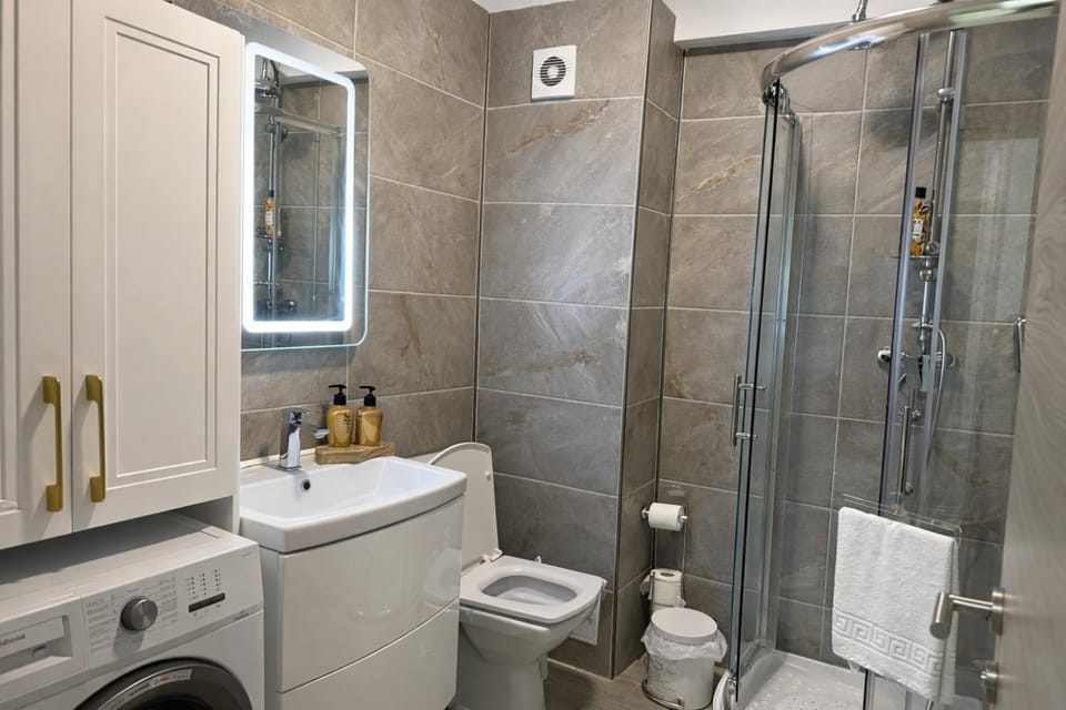 Shower, Toilet, Bathroom, towels, washing machine, dryer
