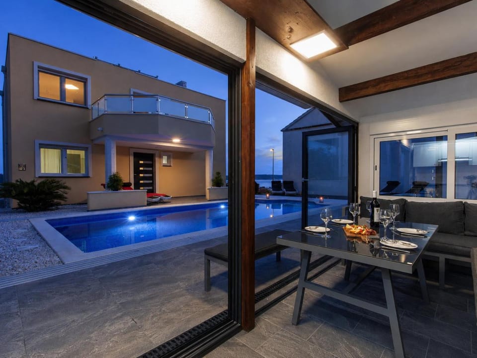 Property building, Night, Balcony/Terrace, Dining area, Pool view, Swimming pool