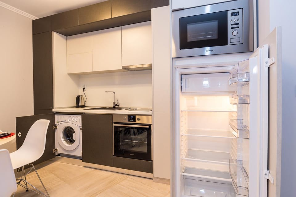 Kitchen or kitchenette, oven, stove, toaster, washing machine