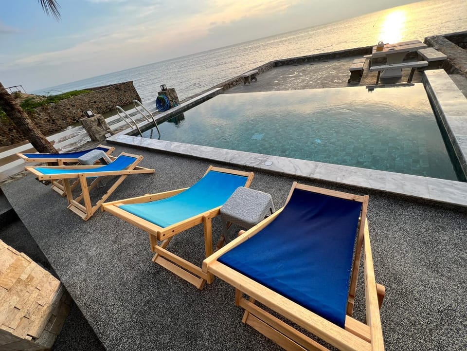View (from property/room), Seating area, Pool view, Sea view, Swimming pool