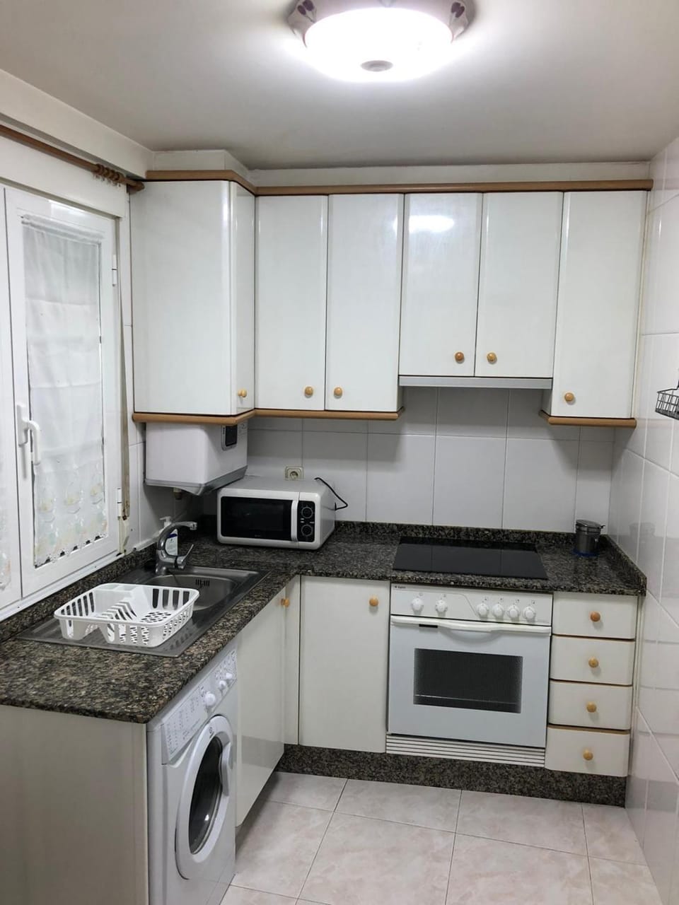 Kitchen or kitchenette, oven, toaster, washing machine