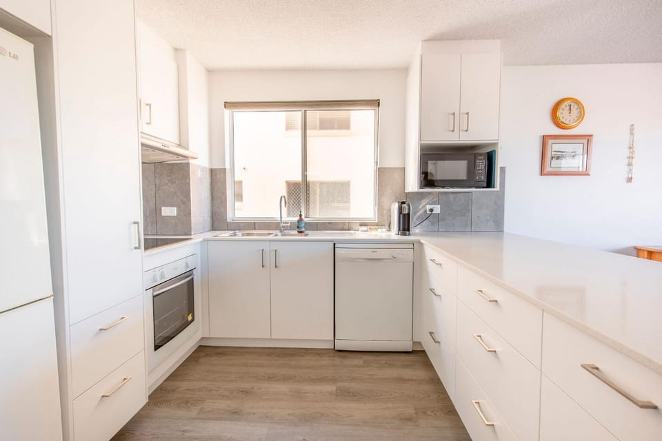 Kitchen or kitchenette, dishwasher, oven, stove