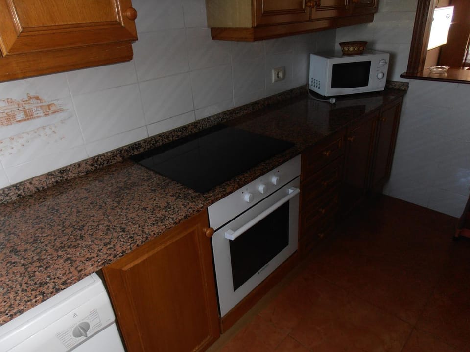 Kitchen or kitchenette, microwave, oven, stove