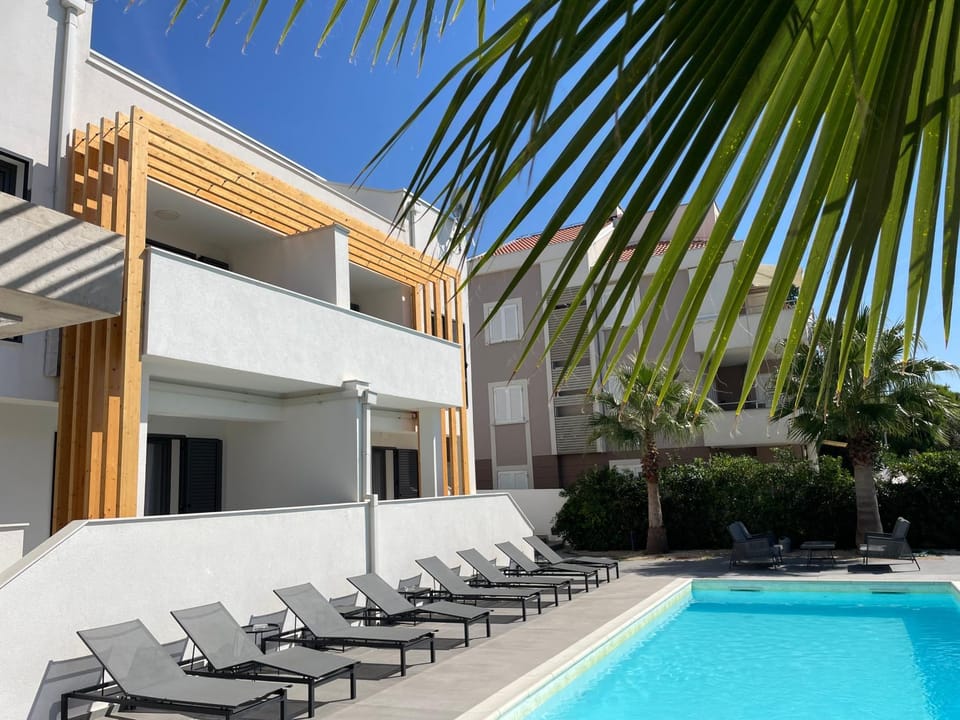 Property building, Patio, Pool view, Swimming pool, sunbed