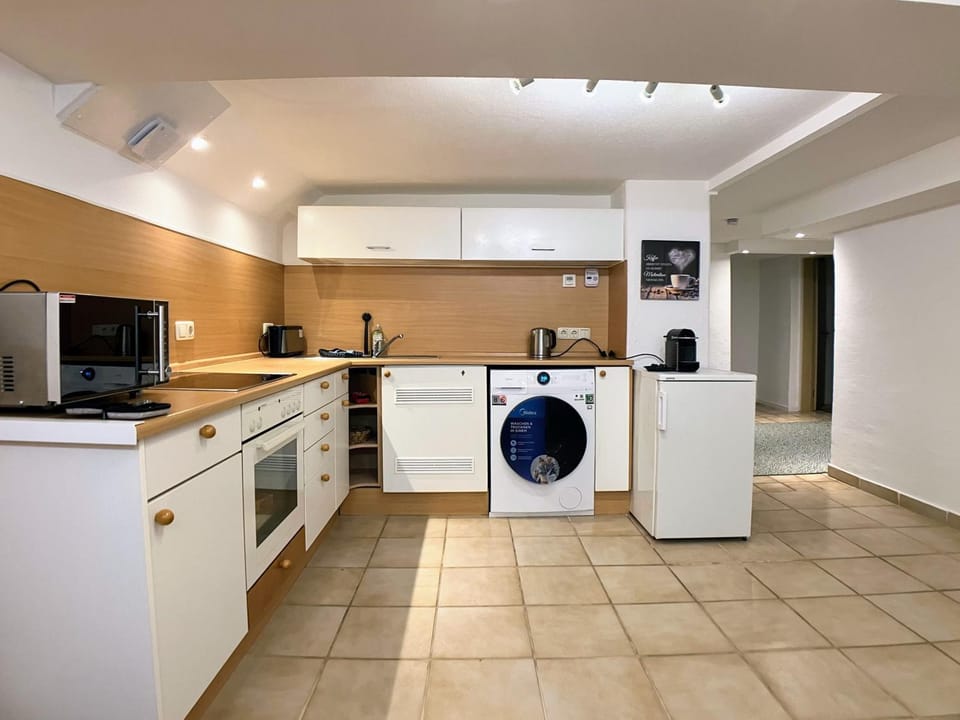 Seating area, microwave, stove, washing machine, kitchen