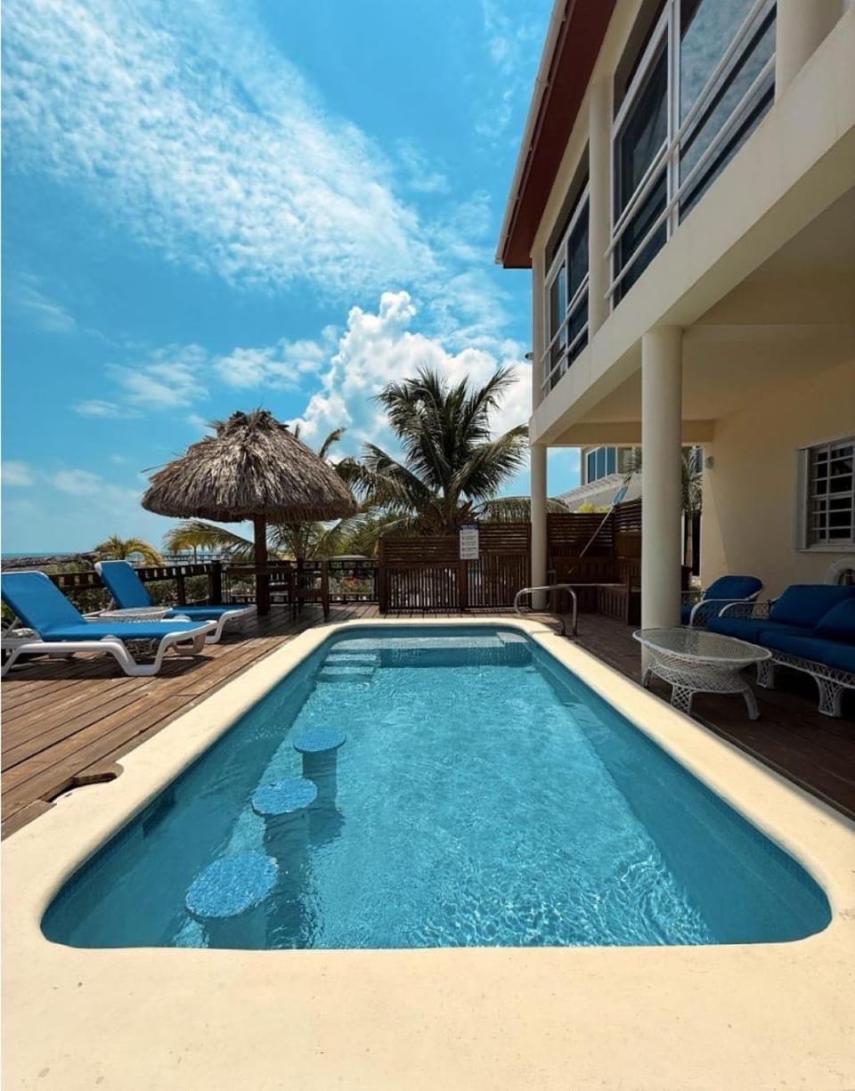 Property building, Patio, Natural landscape, Pool view, Sea view, Swimming pool, sunbed