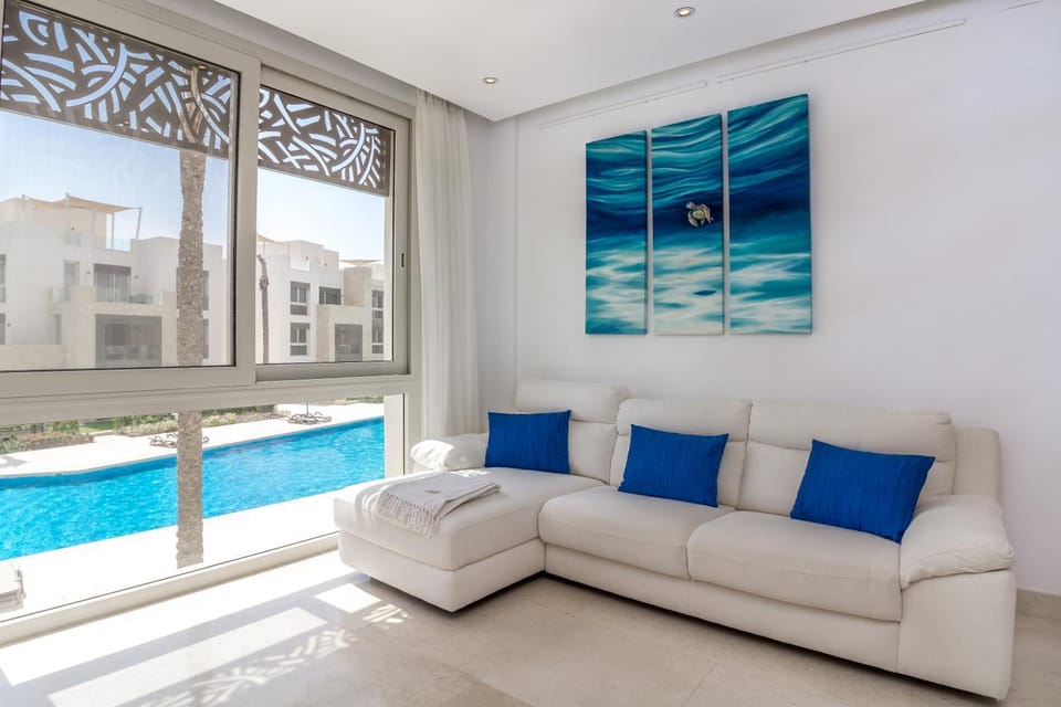 Property building, Patio, Property logo or sign, Living room, Seating area, Pool view, Swimming pool