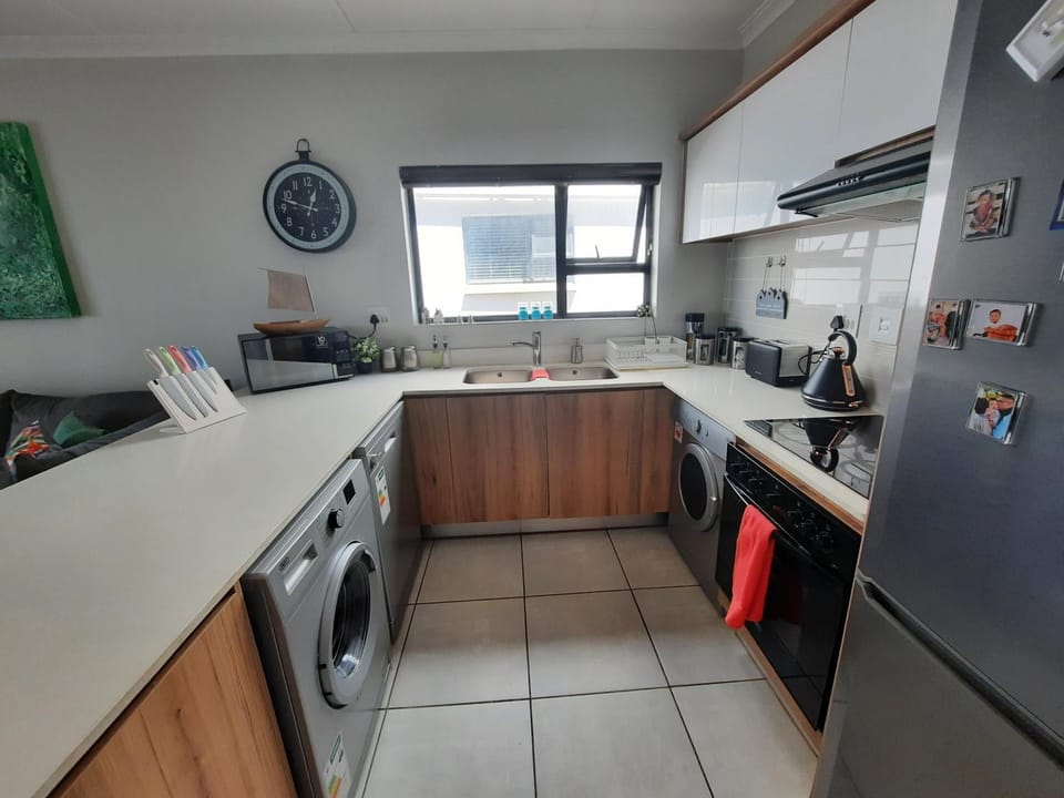Kitchen or kitchenette, dishwasher, oven, stove, toaster, washing machine, dryer