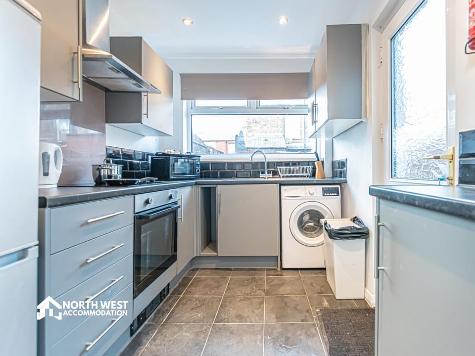 Kitchen or kitchenette, microwave, oven, stove, washing machine, kitchen
