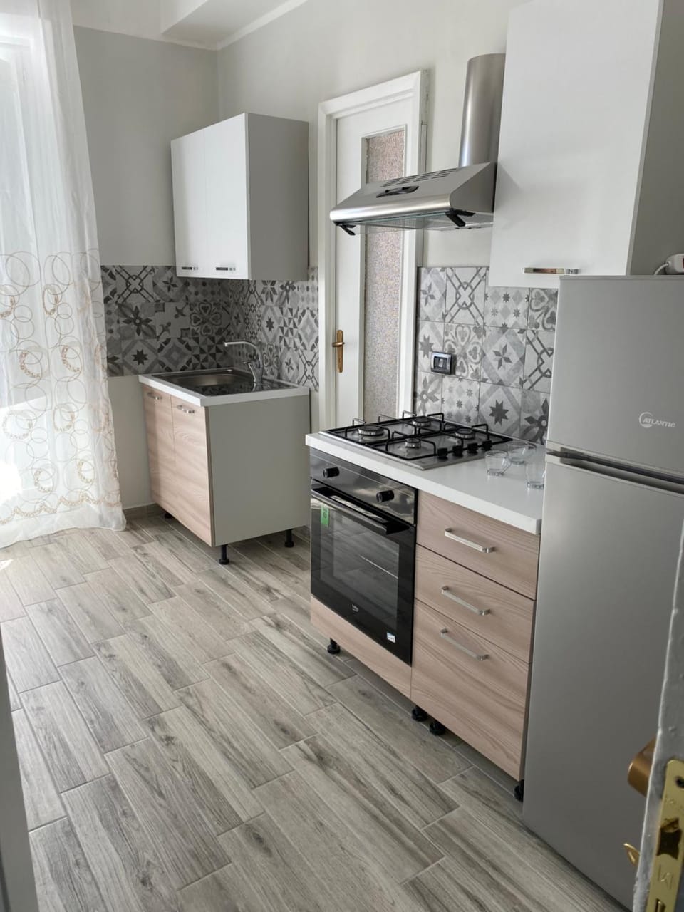 Kitchen or kitchenette, dishwasher, oven, stove