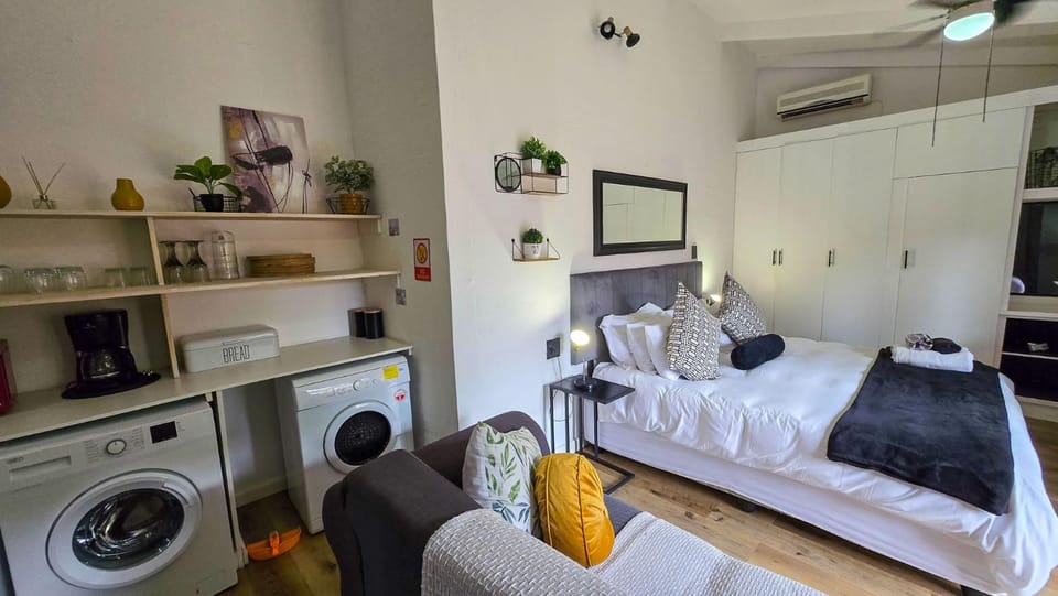 Photo of the whole room, Seating area, towels, washing machine, dryer, air conditioner