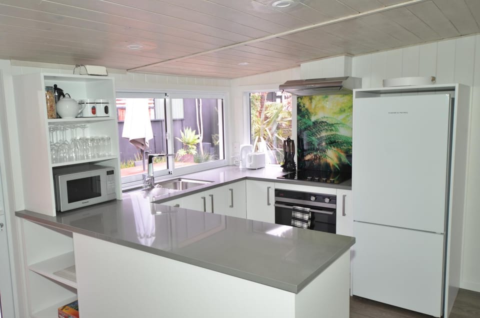Kitchen or kitchenette, dishwasher, oven, stove