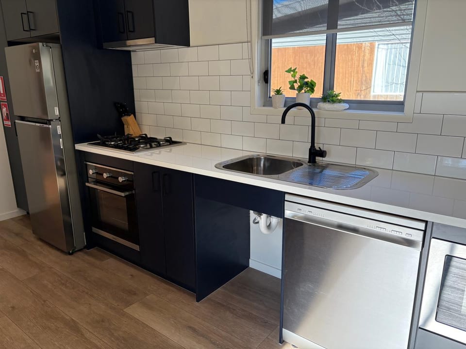 Kitchen or kitchenette, dishwasher, microwave, oven, stove