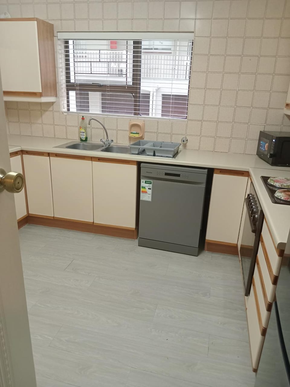 Kitchen or kitchenette, dishwasher, microwave, oven, stove