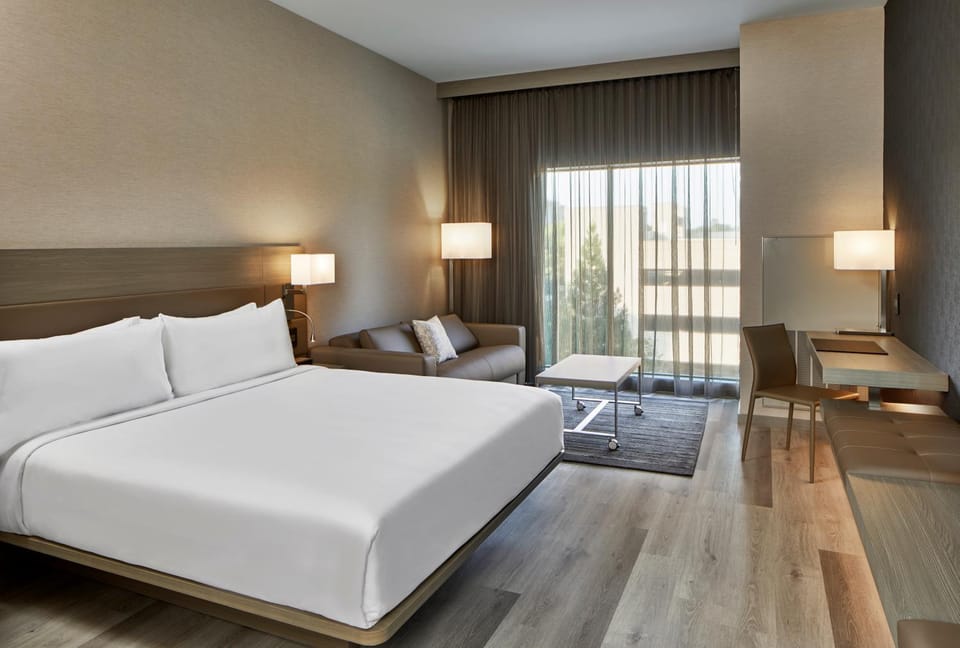 Bed, View (from property/room), Living room, Seating area, Bedroom, City view