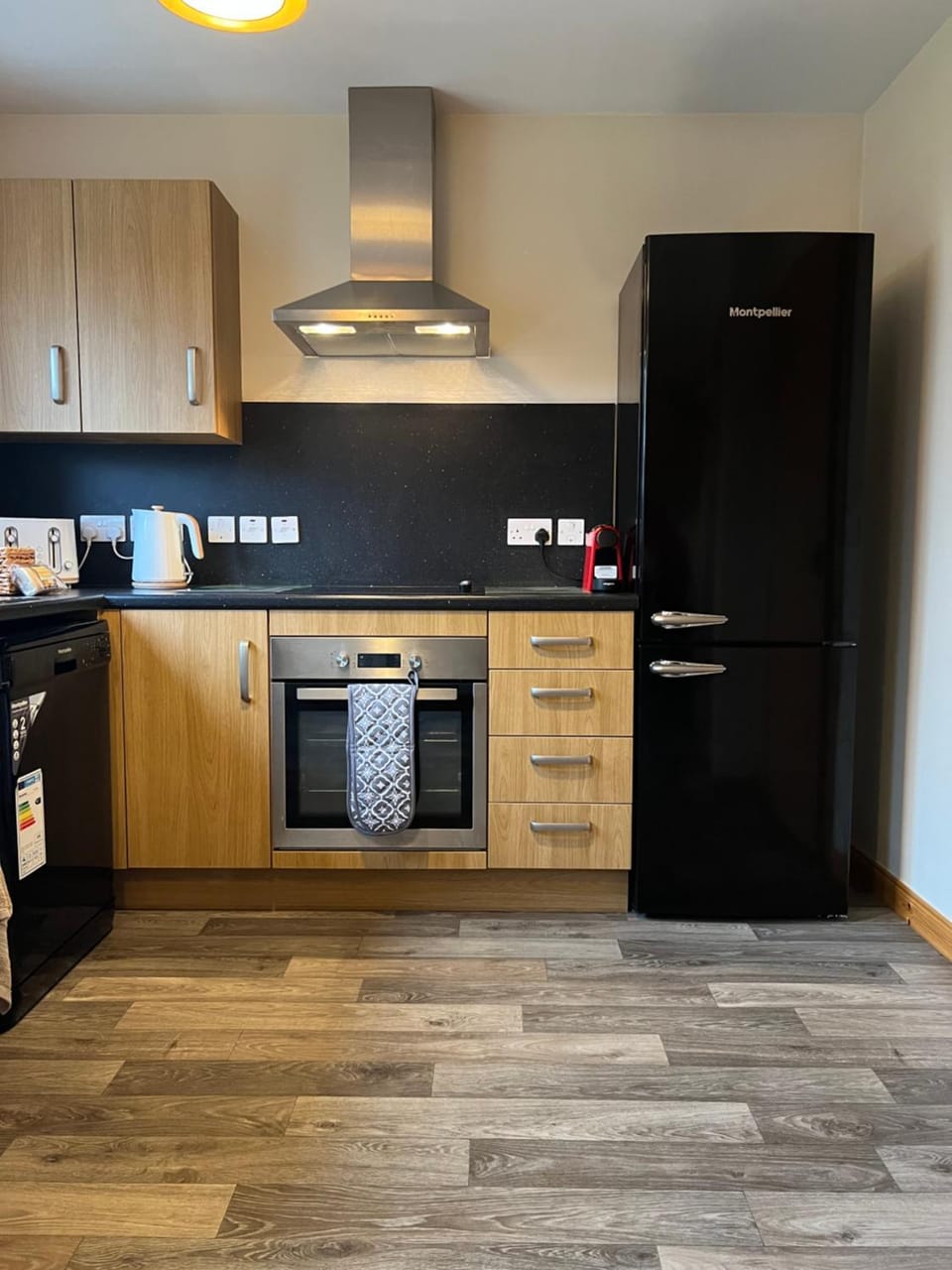 Kitchen or kitchenette, dishwasher, oven, stove