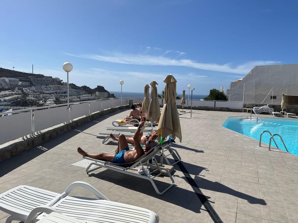 Pool view, Swimming pool, group of guests, sunbed