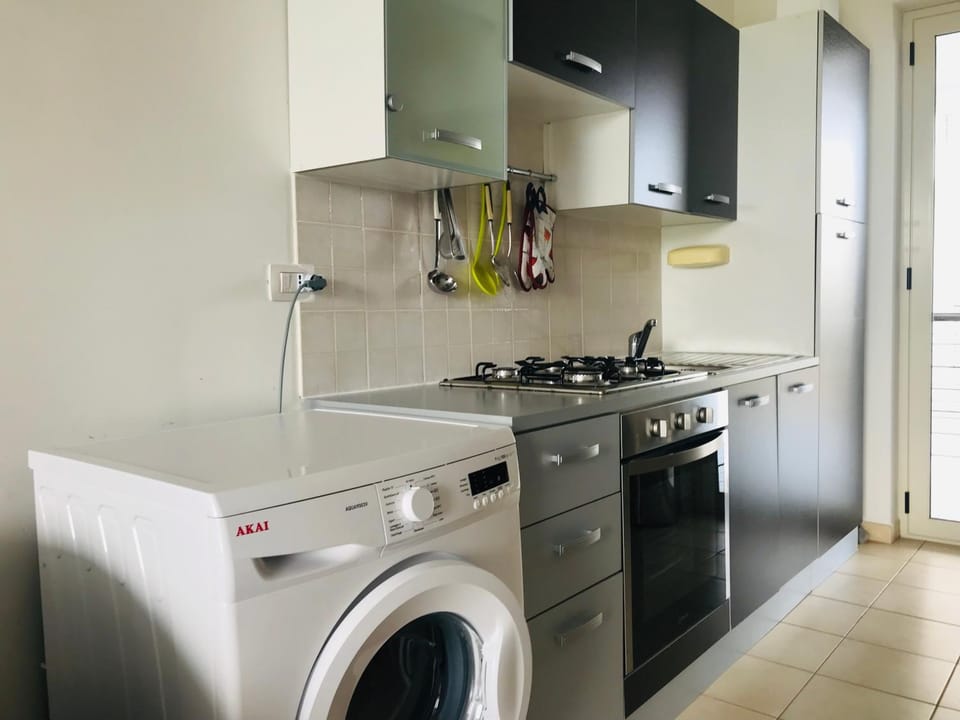 Kitchen or kitchenette, stove, washing machine