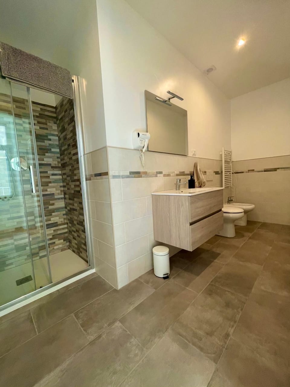 Shower, Toilet, Bathroom, hair dryier, towels, washing machine, dryer