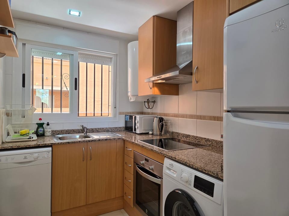 Kitchen or kitchenette, dishwasher, microwave, oven, stove, washing machine, kitchen