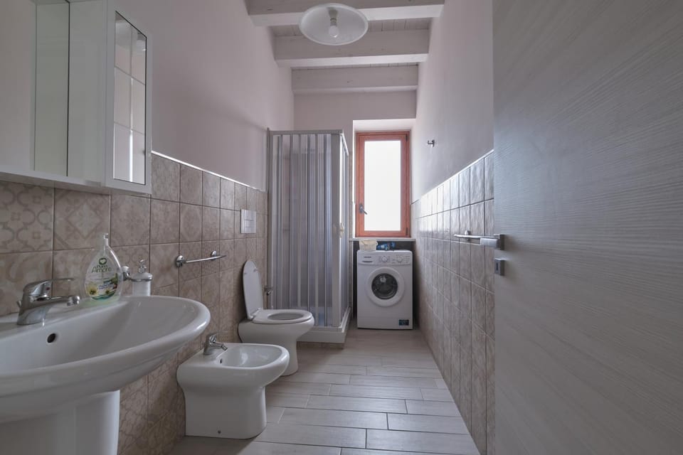 Shower, Toilet, Bathroom, Bath, bidet, towels, washing machine, dryer