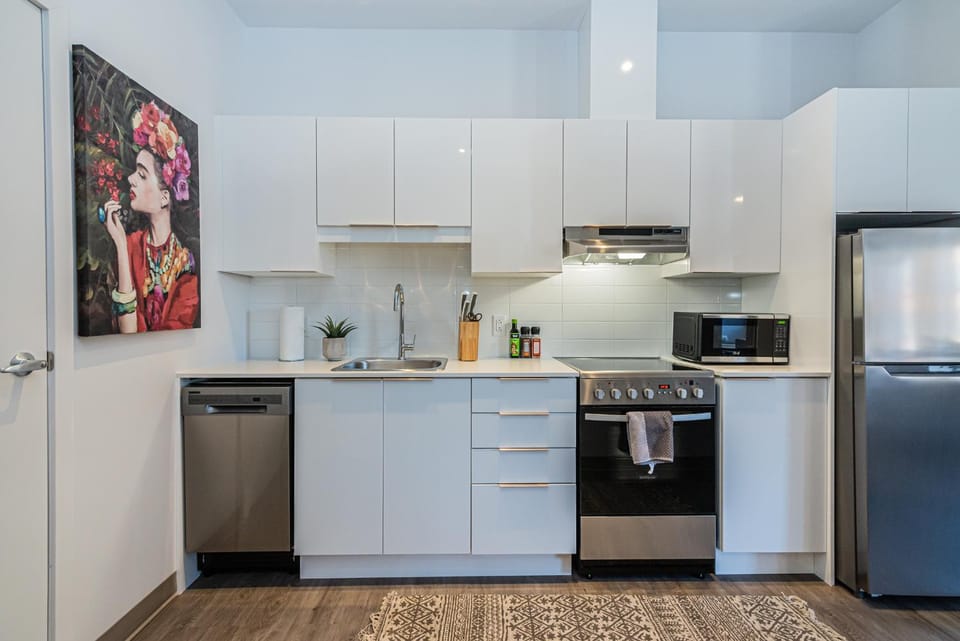 Kitchen or kitchenette, dishwasher, microwave, oven, stove