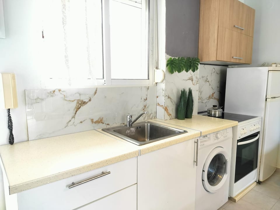 Kitchen or kitchenette, oven, stove, washing machine
