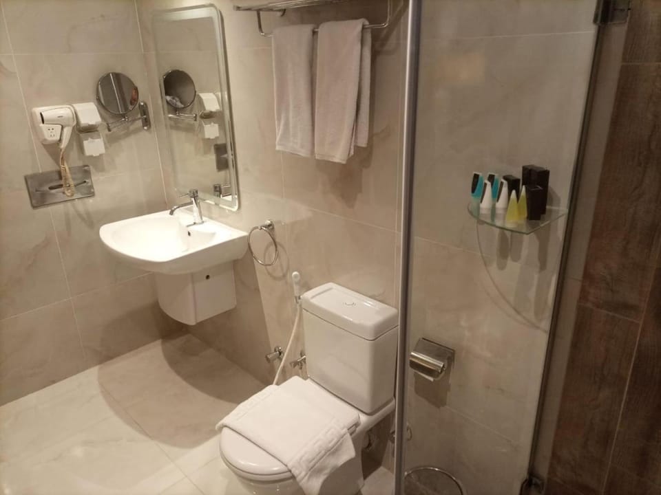 Shower, Toilet, Bathroom, hair dryier, towels