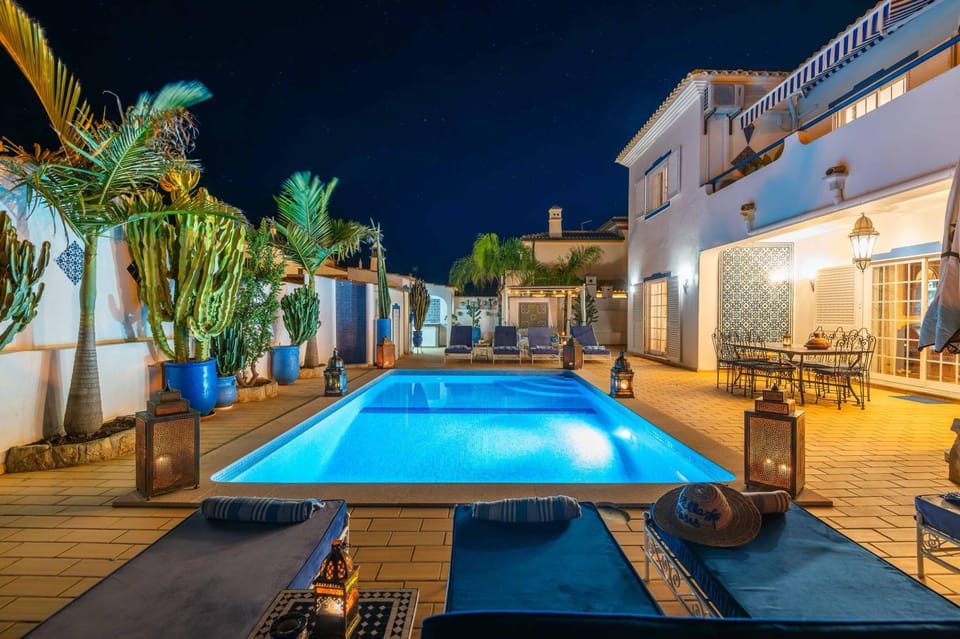 Property building, Patio, Night, Natural landscape, Pool view, Swimming pool, sunbed