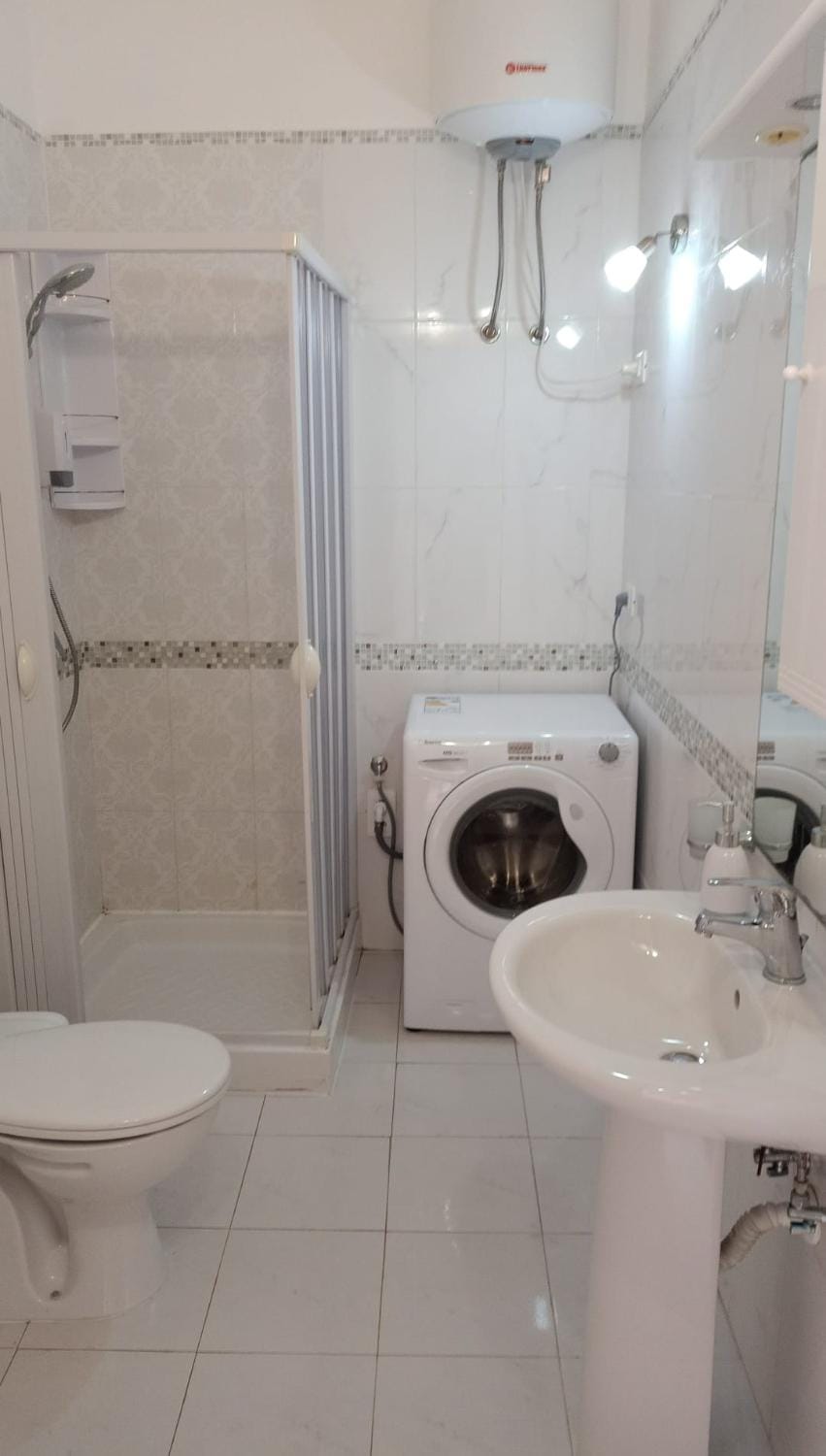 Shower, Toilet, Bathroom, bidet, towels, washing machine
