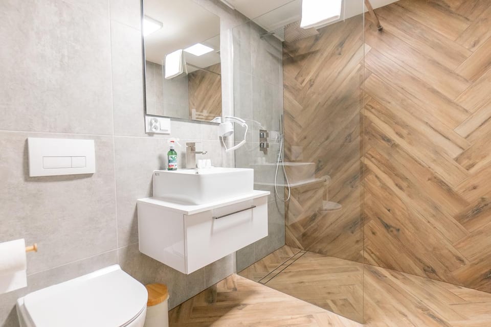 Shower, Toilet, Bathroom, hair dryier, towels, washing machine