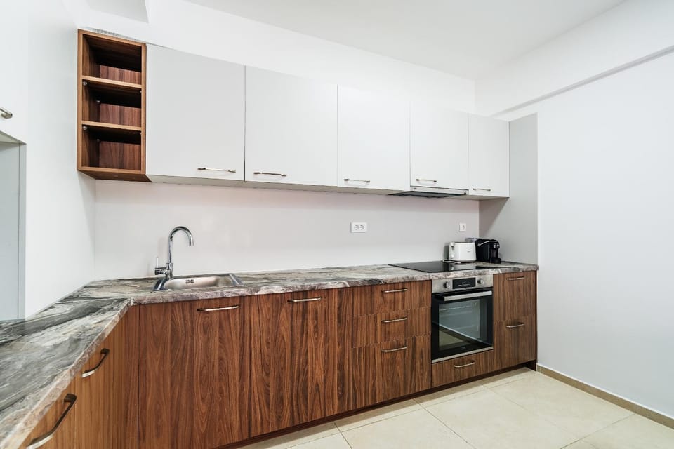 Kitchen or kitchenette, dishwasher, oven, stove