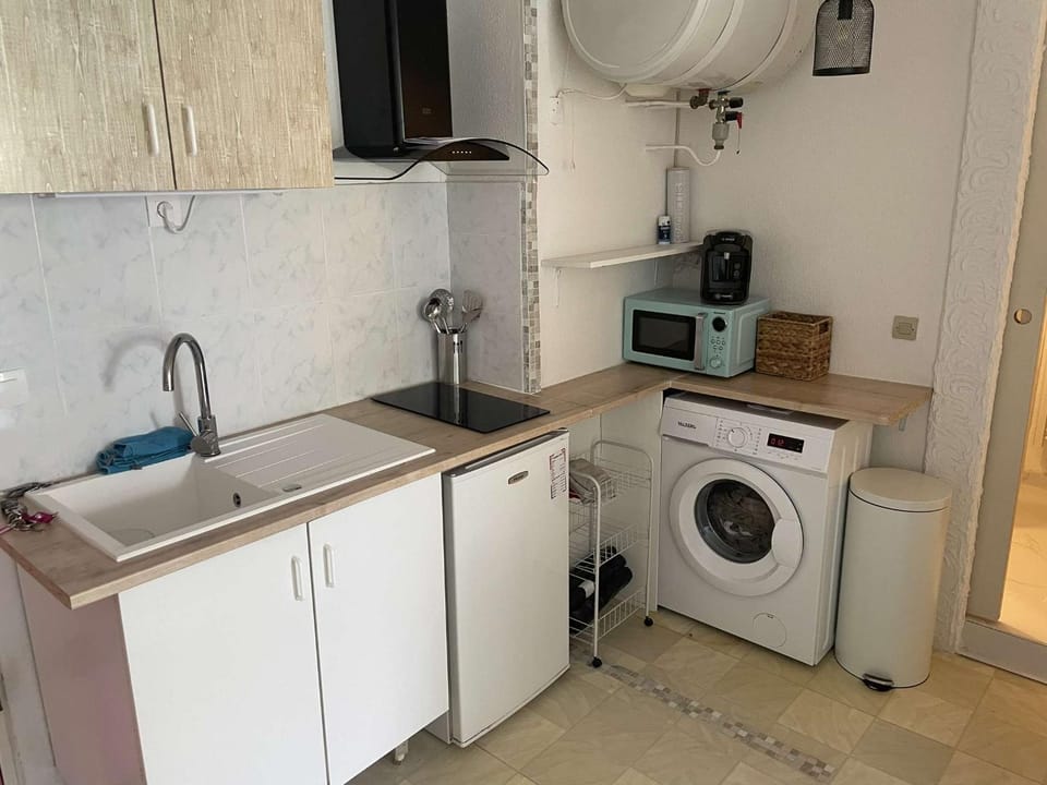 Kitchen or kitchenette, microwave, stove, washing machine