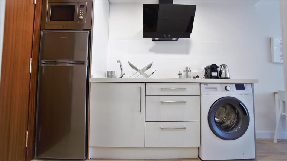 Kitchen or kitchenette, microwave, stove, washing machine