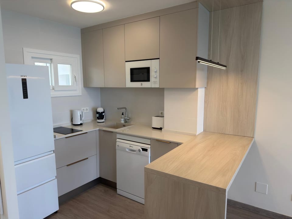 Kitchen or kitchenette, dishwasher, stove, toaster