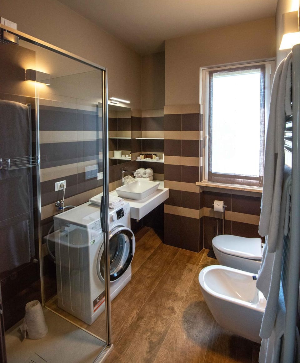 Shower, Toilet, Bathroom, Bath, bidet, towels, washing machine, dryer