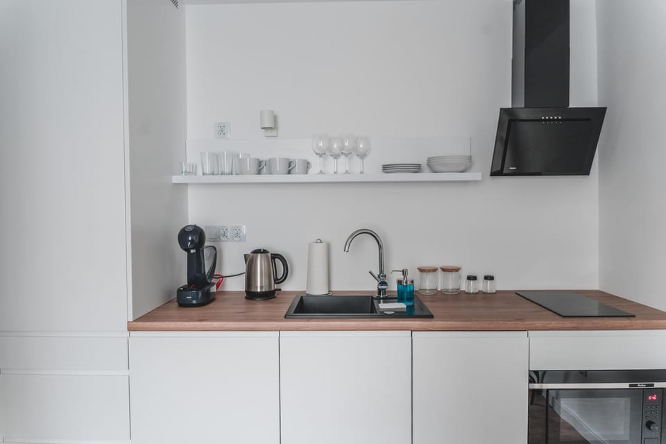 Coffee/tea facilities, Kitchen or kitchenette, Other, Text overlay, Seasons, Time of day, Quiet street view, furniture, locker, minibar, stove