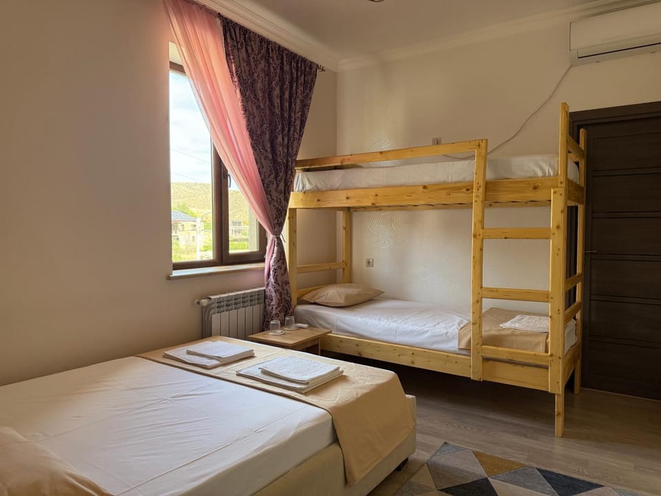 Bed, Photo of the whole room, Bedroom, bunk bed, towels, air conditioner