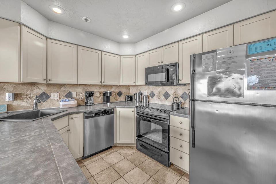 Kitchen or kitchenette, dishwasher, microwave, oven, stove