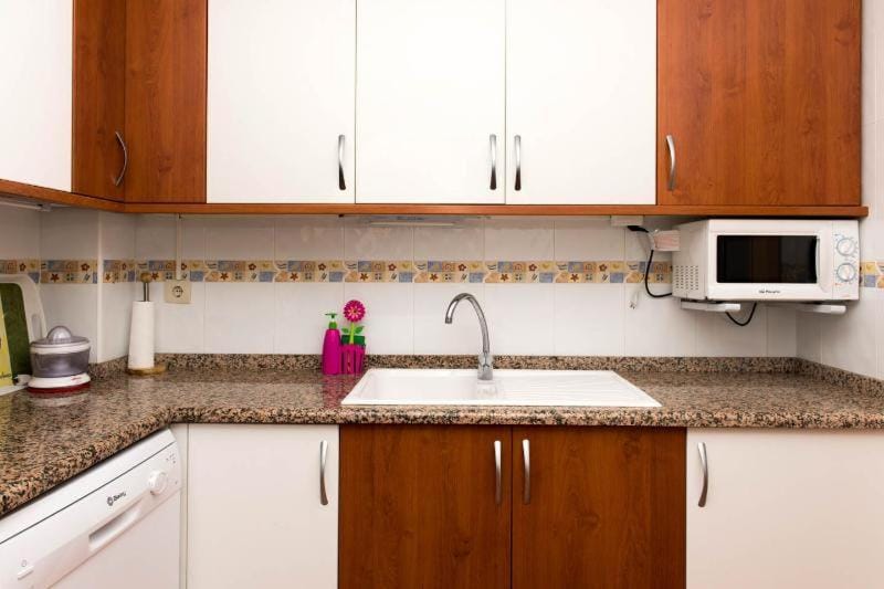 Kitchen or kitchenette, dishwasher, microwave, oven, stove, toaster