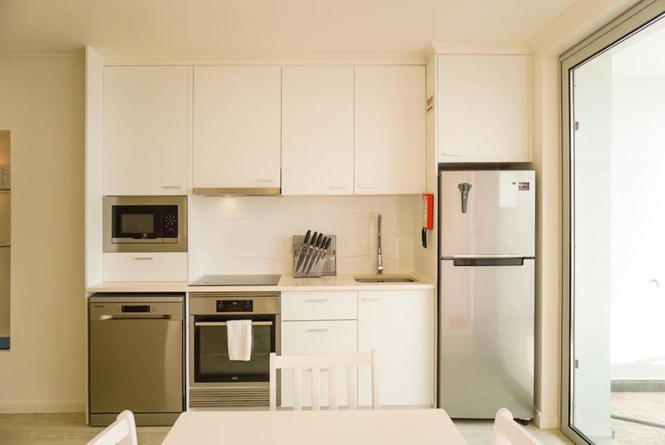 Kitchen or kitchenette, dishwasher, oven, stove