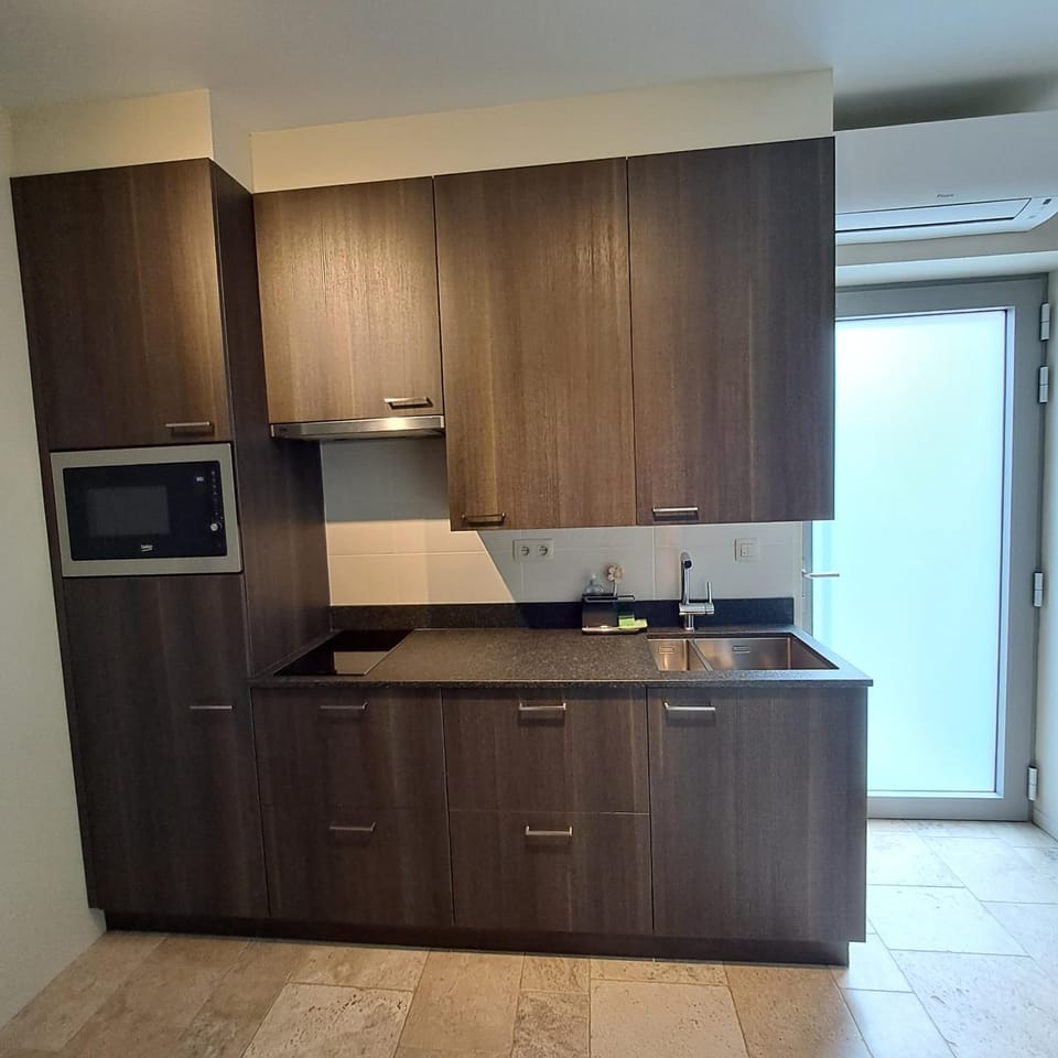 Kitchen or kitchenette, microwave, stove, toaster, air conditioner